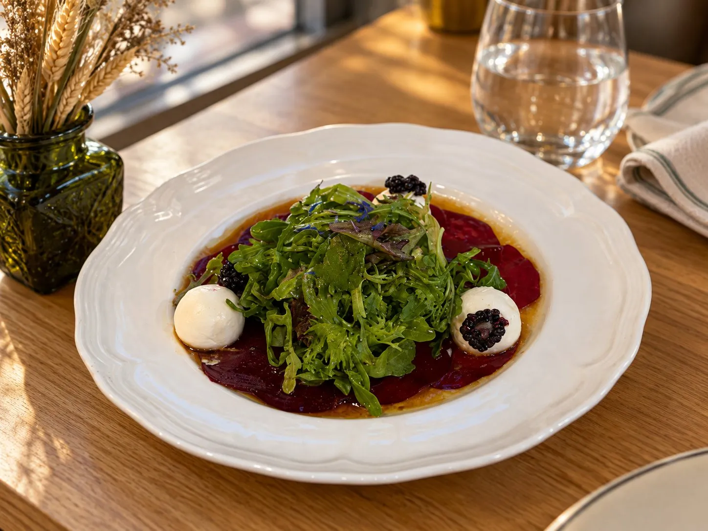Beet carpaccio with goat cheese, arugula and blackberries