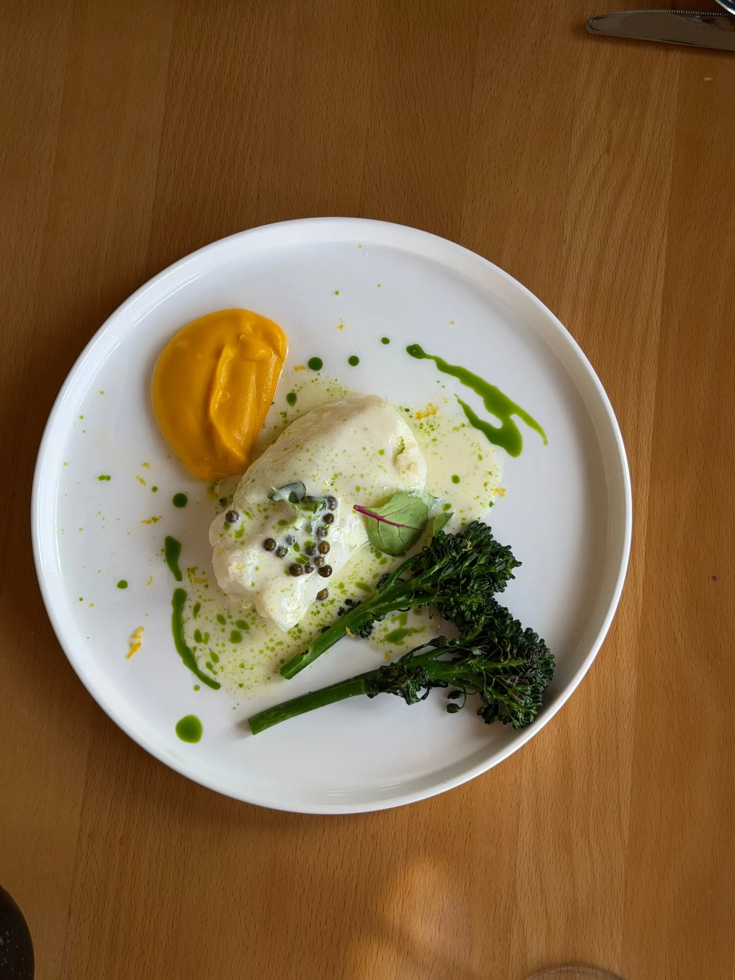 Cod fillet with fish sauce, carrot cream and broccolini
